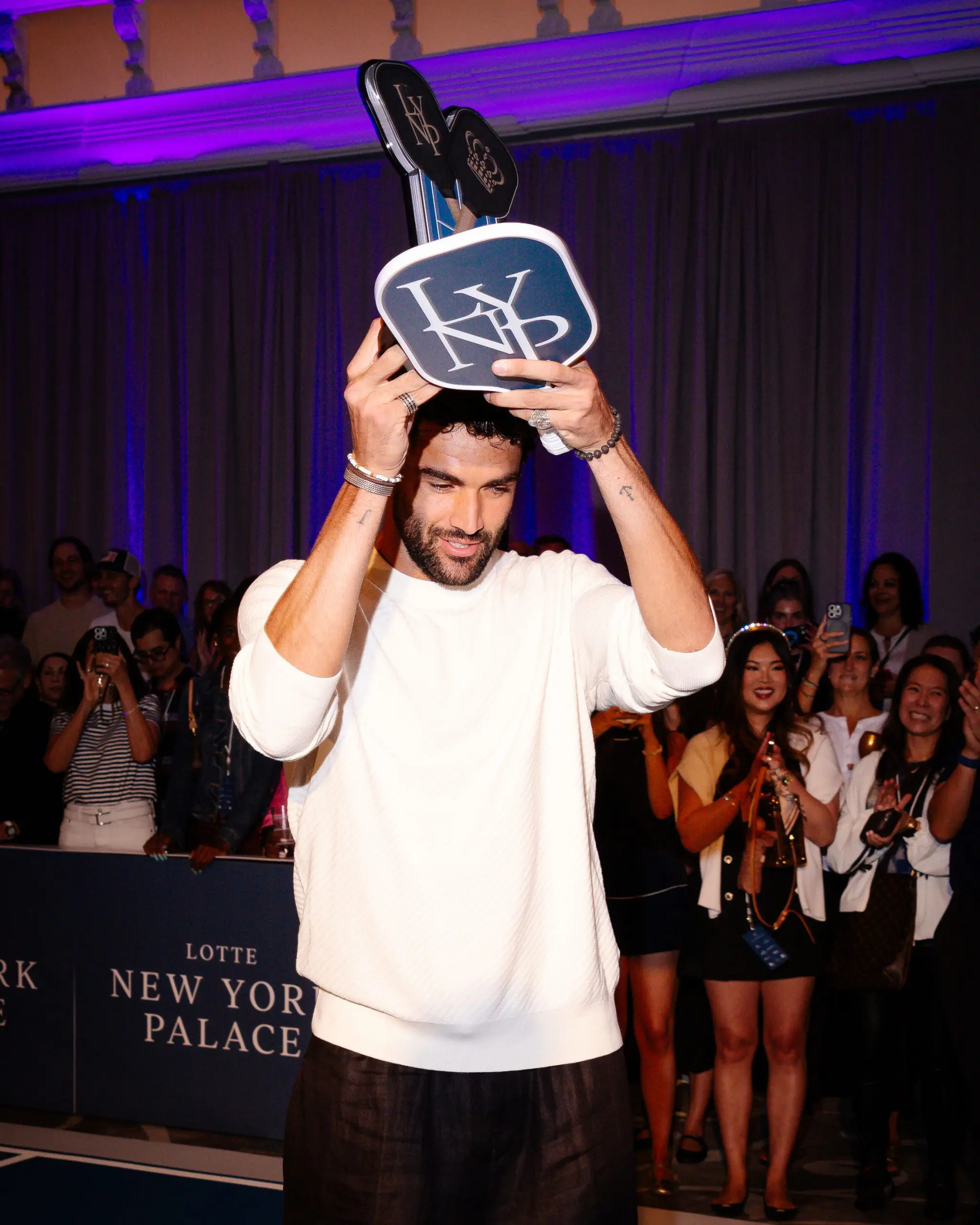 Matteo Berrettini holding up trophy after winning against Taylor Fritz