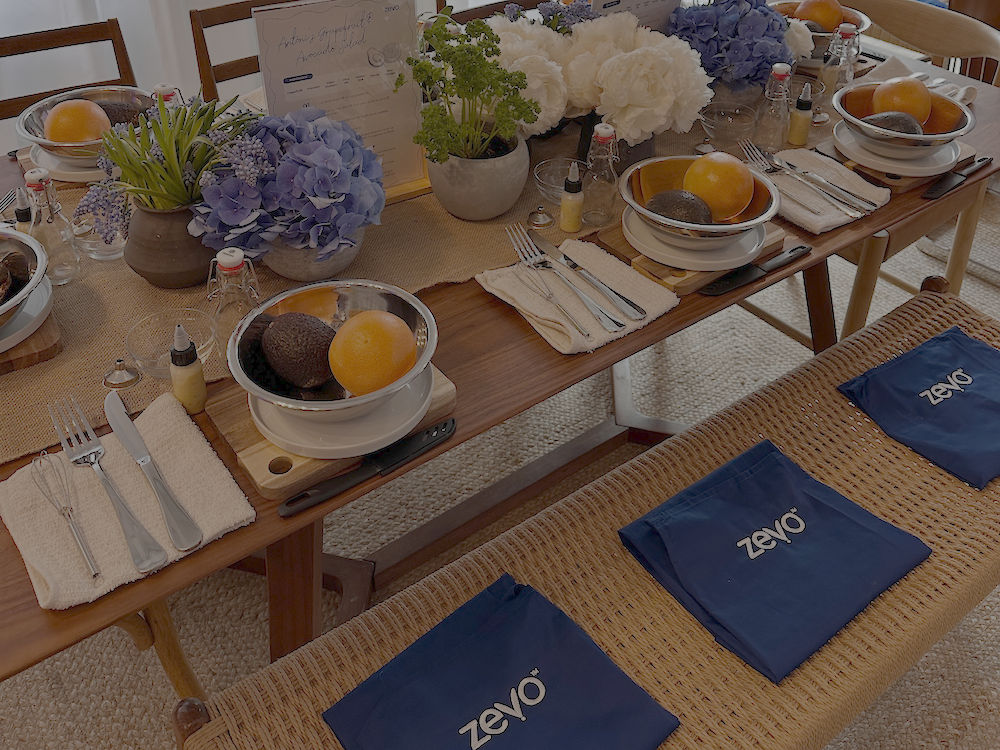 A styled dining table setup featuring grapefruit, avocados and recipe stations during Zevo’s event with Antoni Porowski